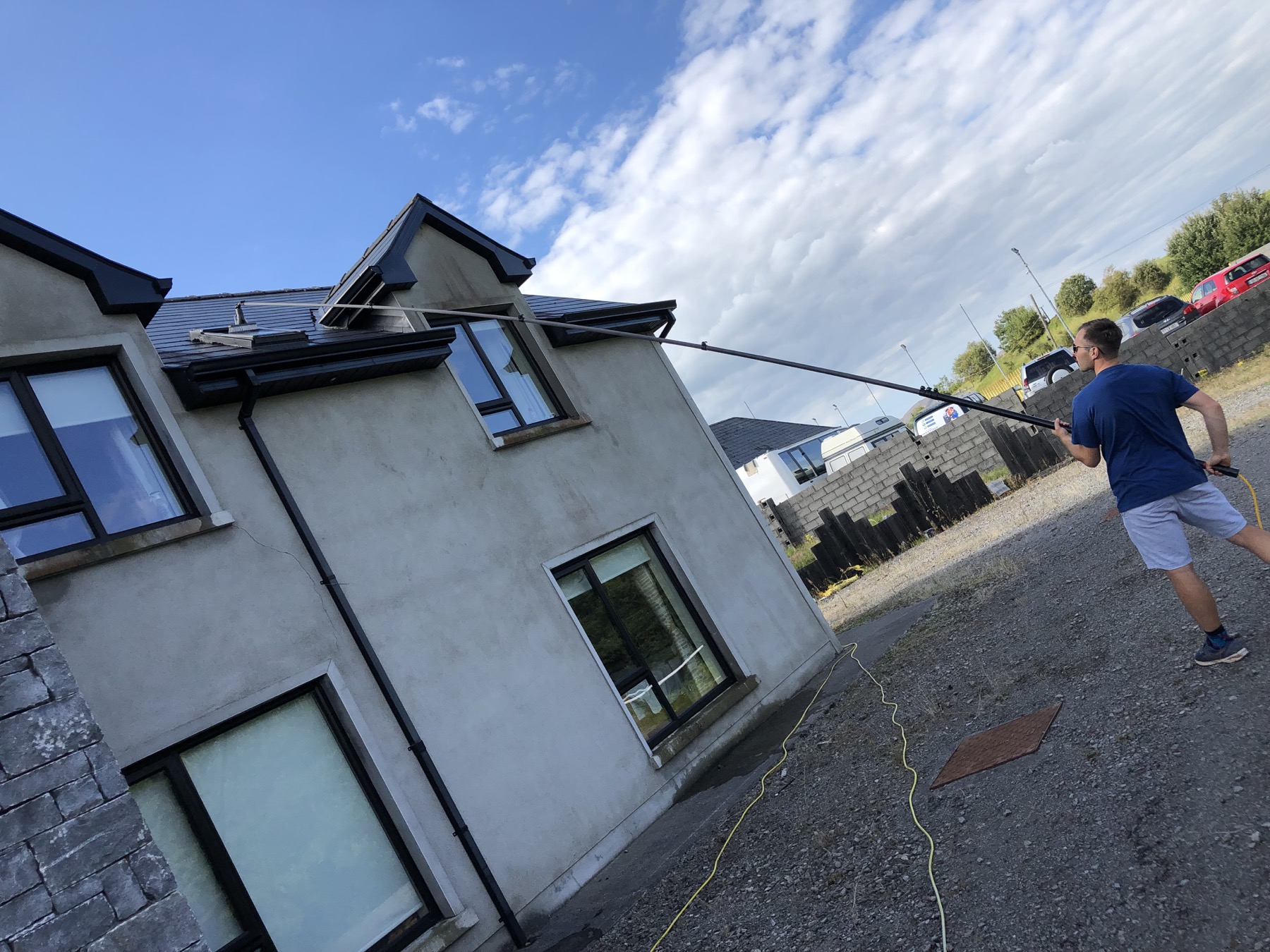 Simon cleaning a home with his long-reach pole